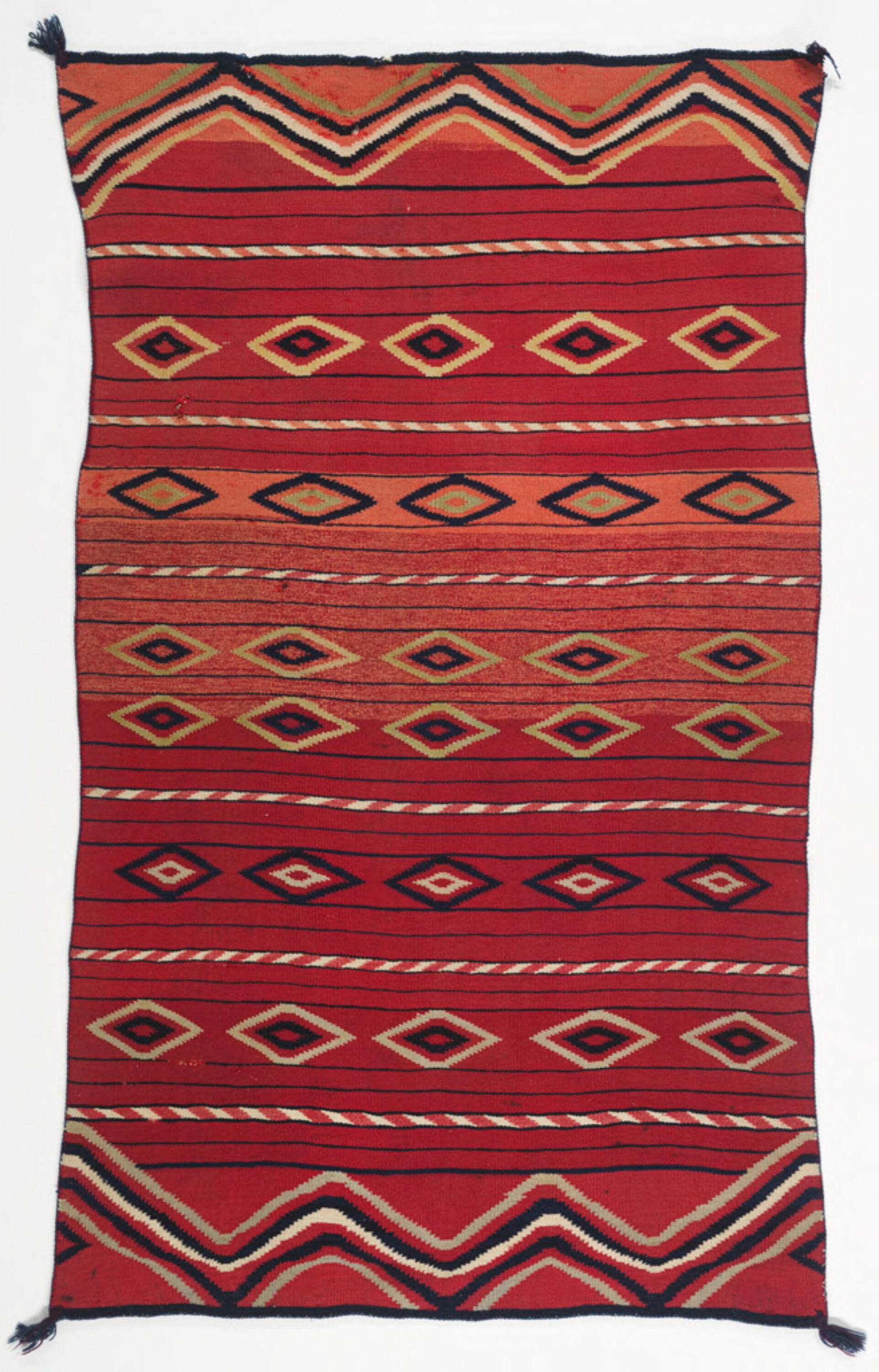 Red, yellow, orange, black, and white Navajo blanket with diamond patterns and horizontal lines